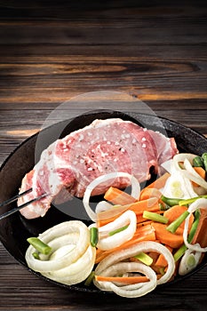 Raw pork chop marinated meat roll with assorted vegetables