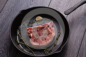 Raw pork chop in pan