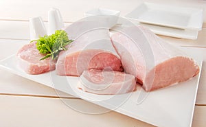 Raw pork chop with tableware photo