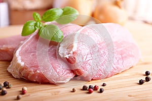 Raw pork chops on cutting board photo