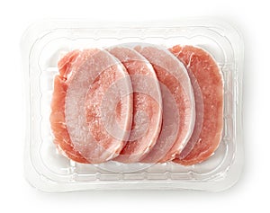 Raw pork chops in plastic try
