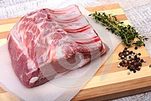 Raw pork chops, spices and rosemary on cutting board. Ready for cooking.