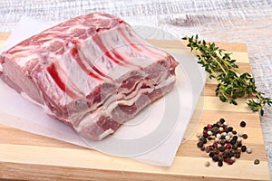 Raw pork chops, spices and rosemary on cutting board. Ready for cooking.