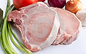 Raw pork chops with vegetables