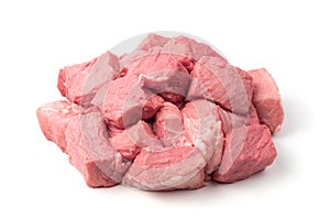 Raw pork cut into chunks on a white background.