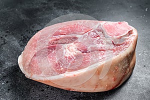 Raw pork ham cut. Leg meat. Black background. Top view