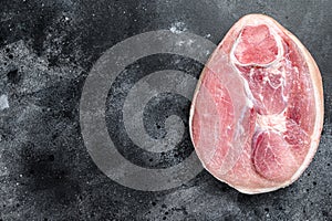 Raw pork ham cut. Leg meat. Black background. Top view. Copy space