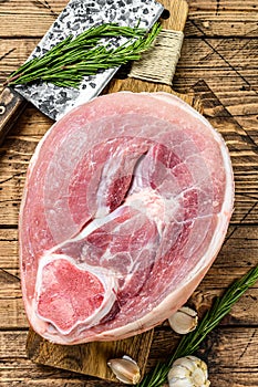 Raw pork ham cut. Leg meat. Wooden background. Top view