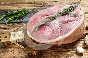 Raw pork ham cut. Leg meat. Wooden background. Top view