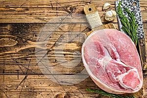 Raw pork ham cut. Leg meat. Wooden background. Top view. Copy space