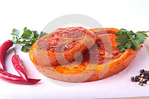 Raw Pork ham with spices, parsley leaves and chilli ready for BBQ grilling isolated on white background.