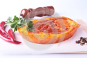 Raw Pork ham with spices, parsley leaves, chilli and spice grinder ready for BBQ grilling isolated on white background.