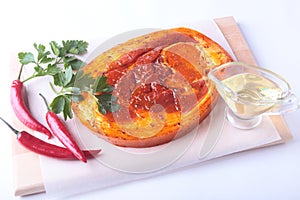 Raw Pork ham with spices and parsley leaves ready for BBQ grilling isolated on white background.