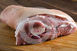 Raw pork knuckle on wood background