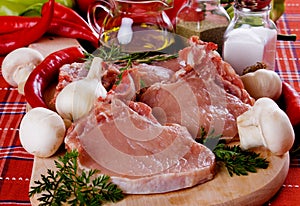 Raw pork loin chops on chopping board