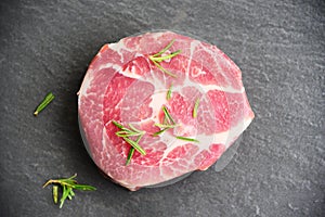 Raw pork meat - Fresh steak ready for grill with spices rosemary on black background