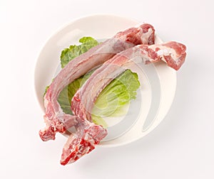 Raw pork meat ribs isolated on white background. Fresh pork meat ribs for barbecue. Strip of pork meat on ribs. BBQ pork ribs isol photo