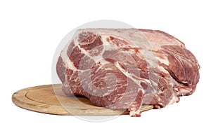 Raw pork meat on a round board