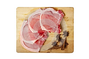 Raw pork meat on a tray and chopping board isolated on white background