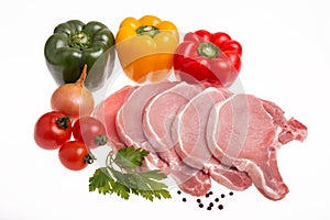 Raw pork meat, vegetables and spices, arranged on kitchen board