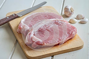 Raw pork meat on wooden board