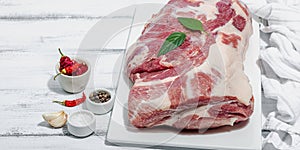 Raw pork neck meat. Traditional ingredients for cooking food. Garlic cloves, fresh parsley