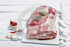 Raw pork neck meat. Traditional ingredients for cooking food. Garlic cloves, fresh parsley