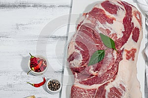 Raw pork neck meat. Traditional ingredients for cooking food. Garlic cloves, fresh parsley