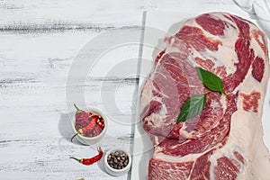 Raw pork neck meat. Traditional ingredients for cooking food. Garlic cloves, fresh parsley