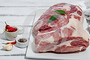 Raw pork neck meat. Traditional ingredients for cooking food. Garlic cloves, fresh parsley