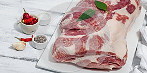 Raw pork neck meat. Traditional ingredients for cooking food. Garlic cloves, fresh parsley