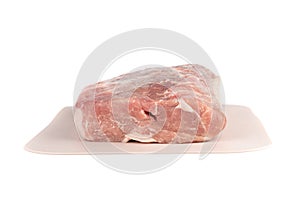 Raw pork on a plastic cutting board over a white background.