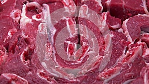 raw pork in refrigerated display case in butcher shop or meat department of supermarket