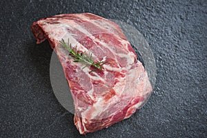 Raw pork ribs meat on black plate background - Fresh pork spare ribs for cooking roasted or grilled , Pork bone with rosemary