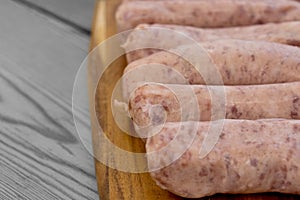 Raw pork sausages on a chopping board