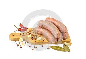 Raw pork sausages. Grilled sausages, spices close-up, isolated on a white background.Selective focus