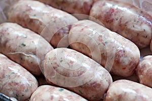 Raw pork sausages in natural casing.