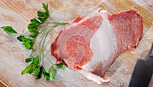 Raw pork secreto fillet and greens