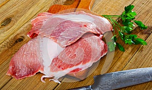 Raw pork secreto fillet and greens photo