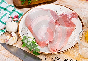 Raw pork secreto steak and spices prepared for cooking on plate photo