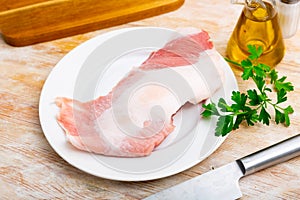 Raw pork secreto steak and spices prepared for cooking on plate photo