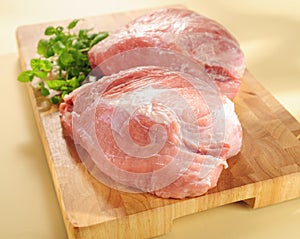 Raw pork shoulder. Arrangement on a cutting board. photo