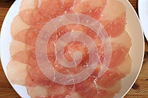 Raw pork sliced in white dish for shabushabu, Japanese recipe