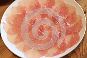 Raw pork sliced in white dish for shabushabu, Japanese recipe