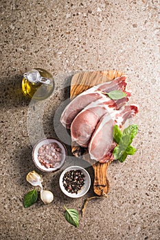 Raw pork  steaks with spices, herbs on cutting  board. Fresh meat. Top view copy space