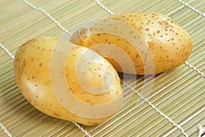 Raw potato on bamboo mat