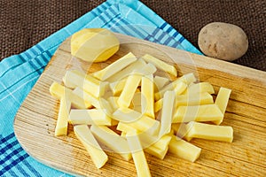 Raw potato sliced strips prepared for fries