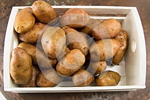 Raw potatoes in a basket