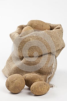 Raw potatoes in burlap bag