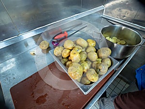 raw potatoes with peeled skin on the wooden desk on the table. High quality photo